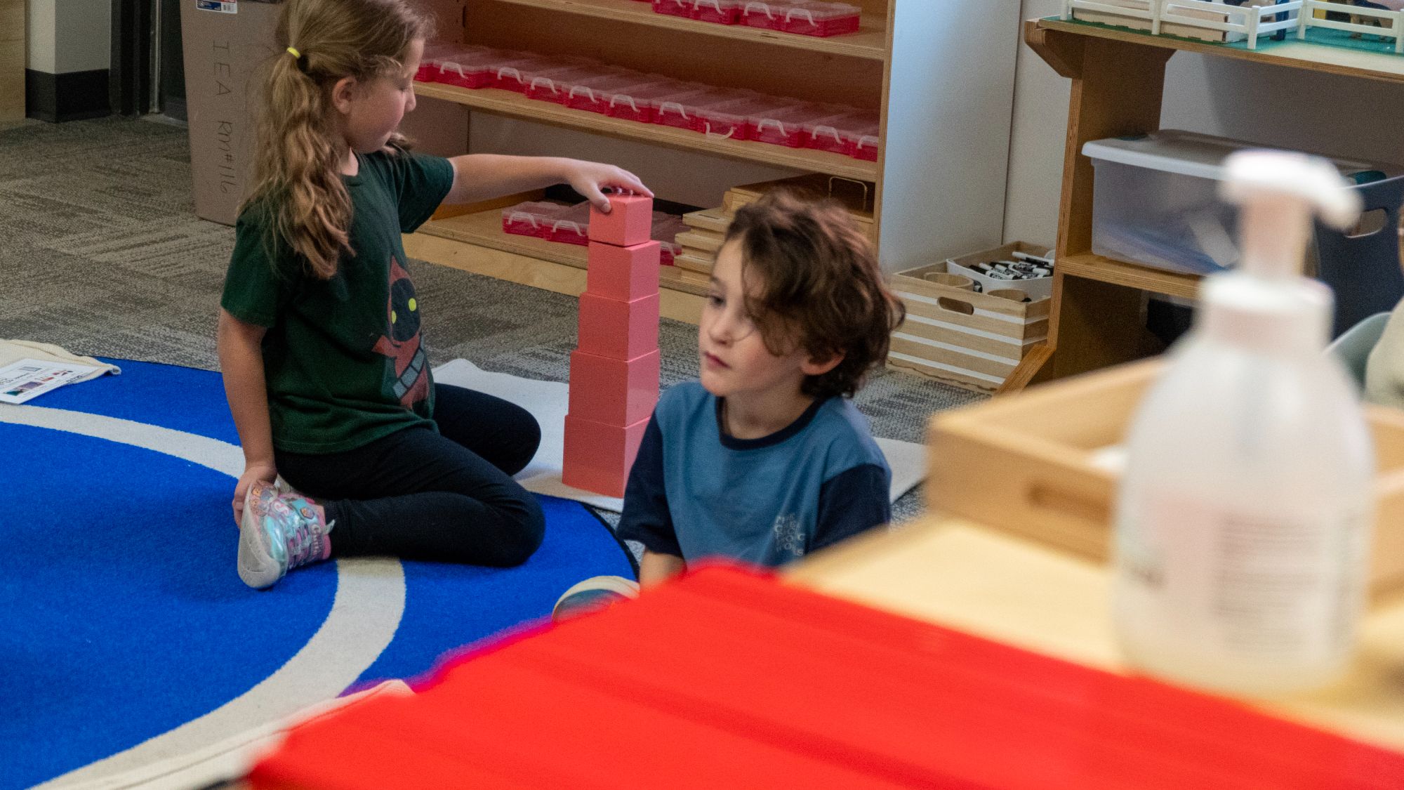 Girl stacking pink blocks