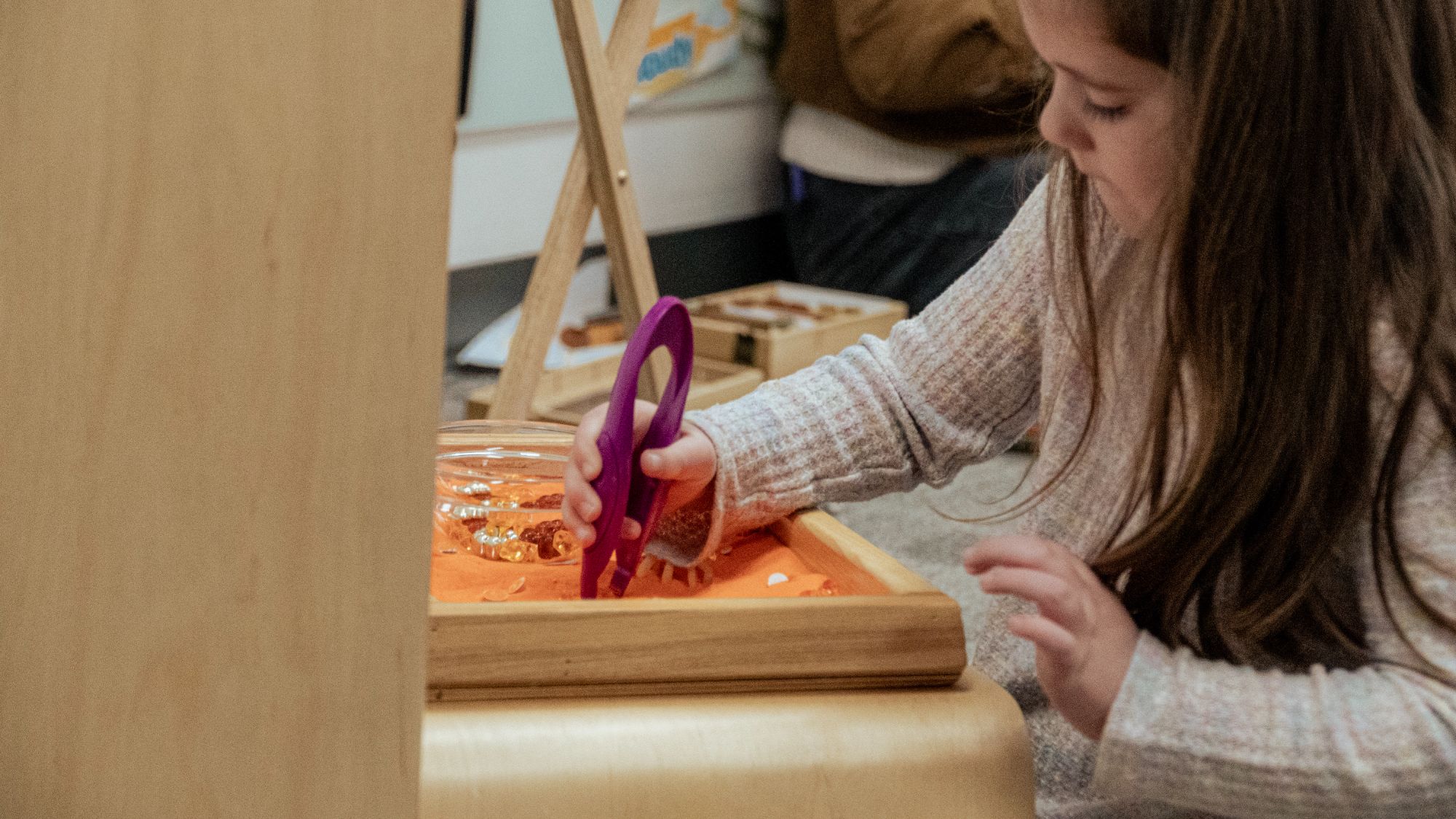 Student picking up beads with tweezers